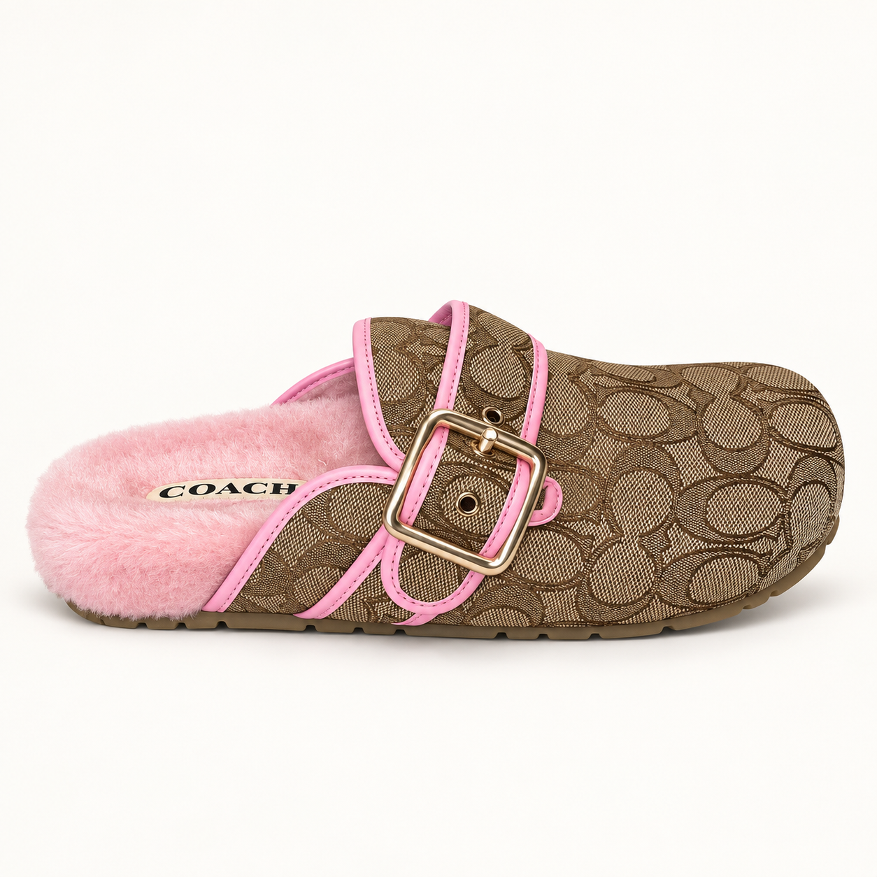 Coach signature clog held in hand, pink shearling lining